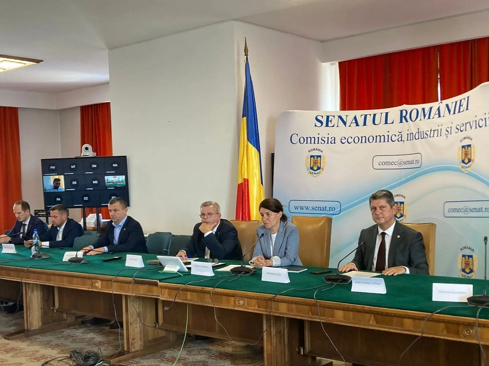 Titus Corlatean and Romanian officials and representatives seated at a long table during a formal meeting, with a Romanian flag and a banner reading 'Senatul României' in the background.